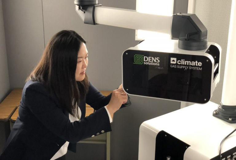 Yuanyuan Zhu, director of the InToEM center, works with the DENSsolutions Climate system at UConn Tech Park. (UConn Photo)
